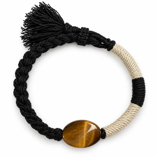 Tiger eye bracelet with a golden-brown oval stone on half black braided, half cream-wrapped cord with a black tassel