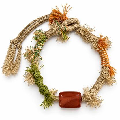 Boho bracelet with a rectangular carnelian stone on sand-colored twisted cord with orange and green wraps and frayed fringe