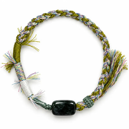 Moss agate bracelet with a dark green rectangular stone on olive and pastel twisted cord with white wraps and fringe
