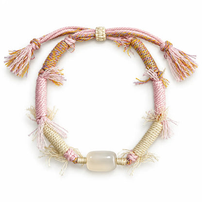 Crystals for love bracelet with a milky barrel-shaped quartz stone on pink and cream wrapped cord with fringe