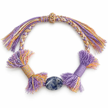 Crystals for mental clarity bracelet with an oval white and blue sodalite stone on lavender braided cord with full tassels