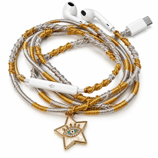 Pearly white star charm with evil eye on hand-wrapped gold and silver wired earphones with USB-C connector