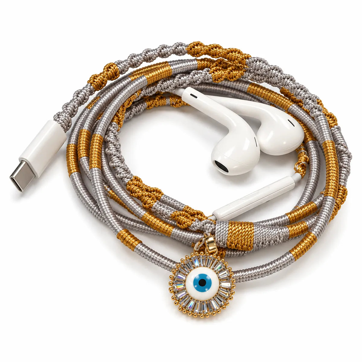 Sunburst evil eye charm with baguette stone halo on hand-wrapped gold and silver wired earphones