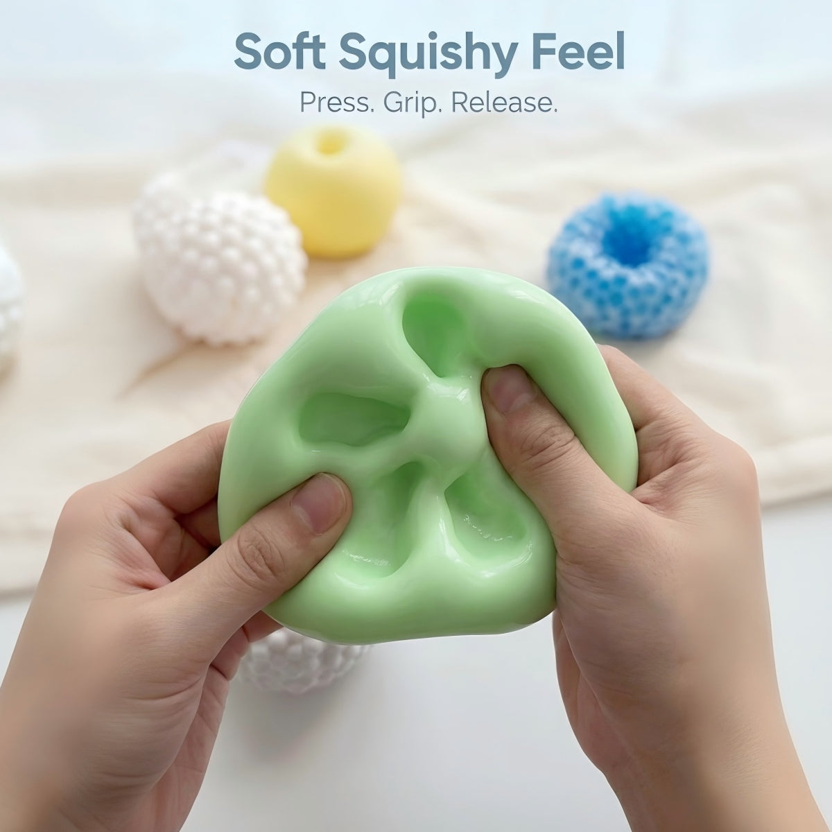 Adult hands squeezing a soft green squishy stress ball to show a press, grip, and release feel for everyday fidgeting