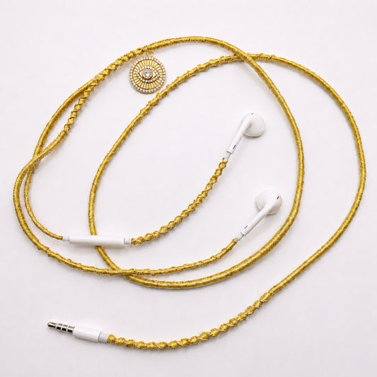 evil eye sunburst medallion earphone charm on white background
