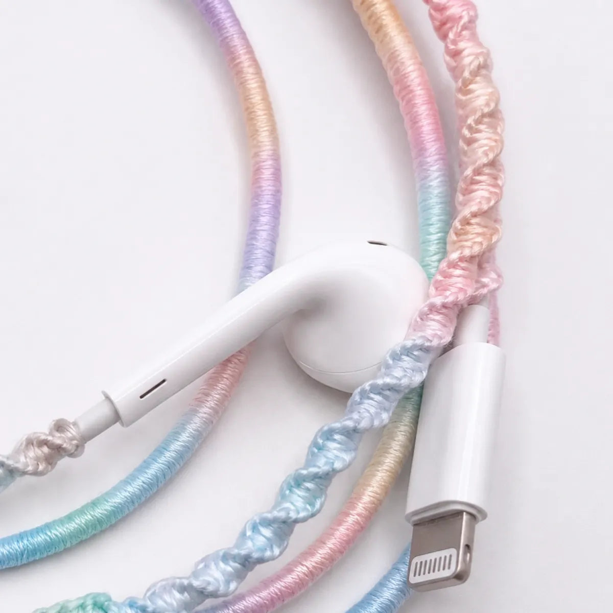  Extreme macro of lavender dominant pastel gradient wrapped earphone cord showing detailed soft purple spiral thread blending into blush and mint for fairycore pastel detail ad 