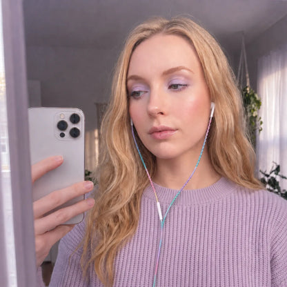 Bedroom mirror selfie of ethereal young woman in lavender ribbed knit sweater with lavender dominant gradient wrapped earphones as a soft fairycore necklace 