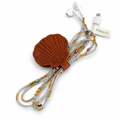 seashell earbuds case with gold and silver braided wired earbuds extended