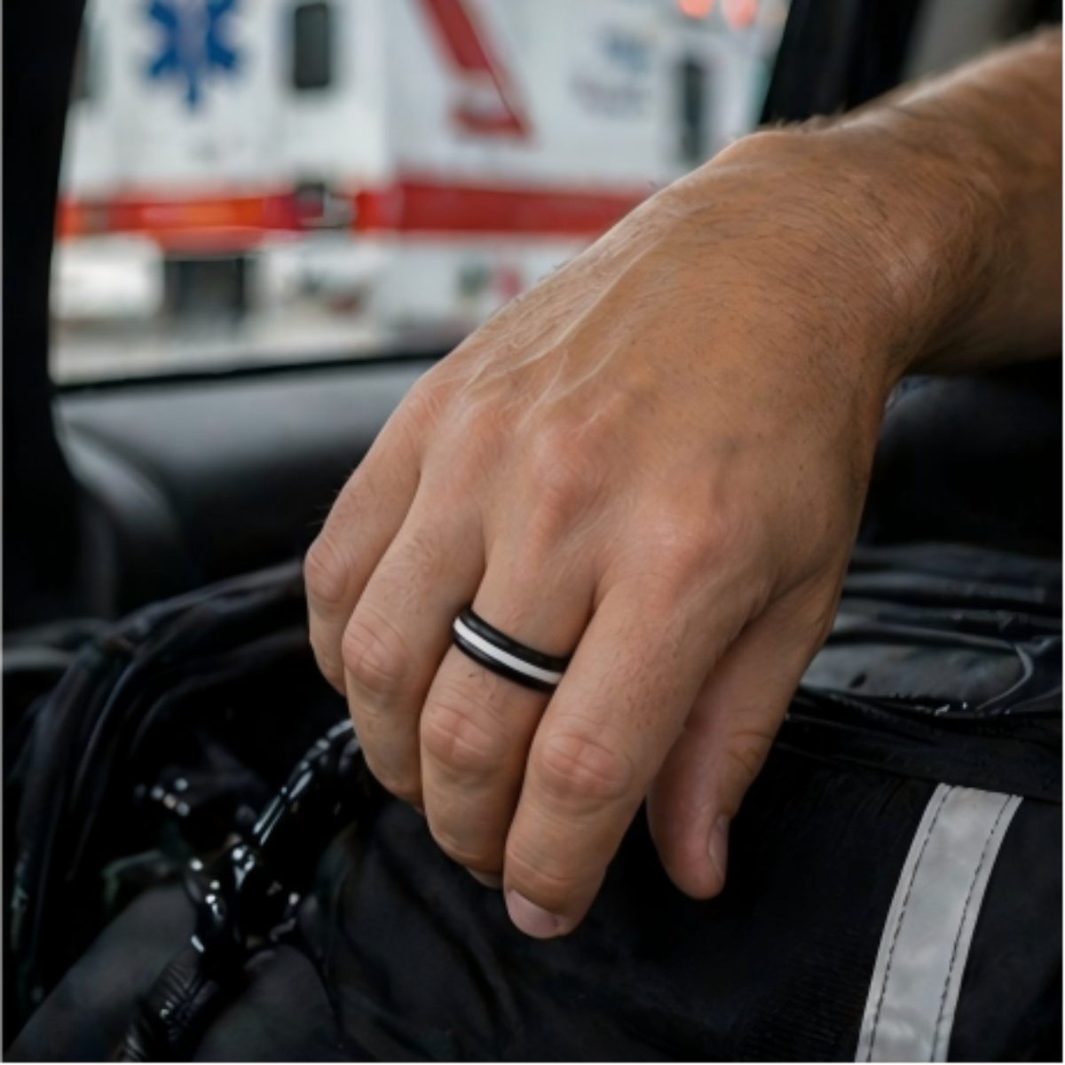 men's black and white EMS tribute silicone ring worn near ambulance duty gear