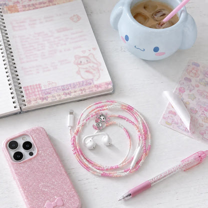  Kawaii pink axolotl earphone wrap on a white desk with washi-tape journal, character-style mug, kawaii stickers, and sparkly pink phone 